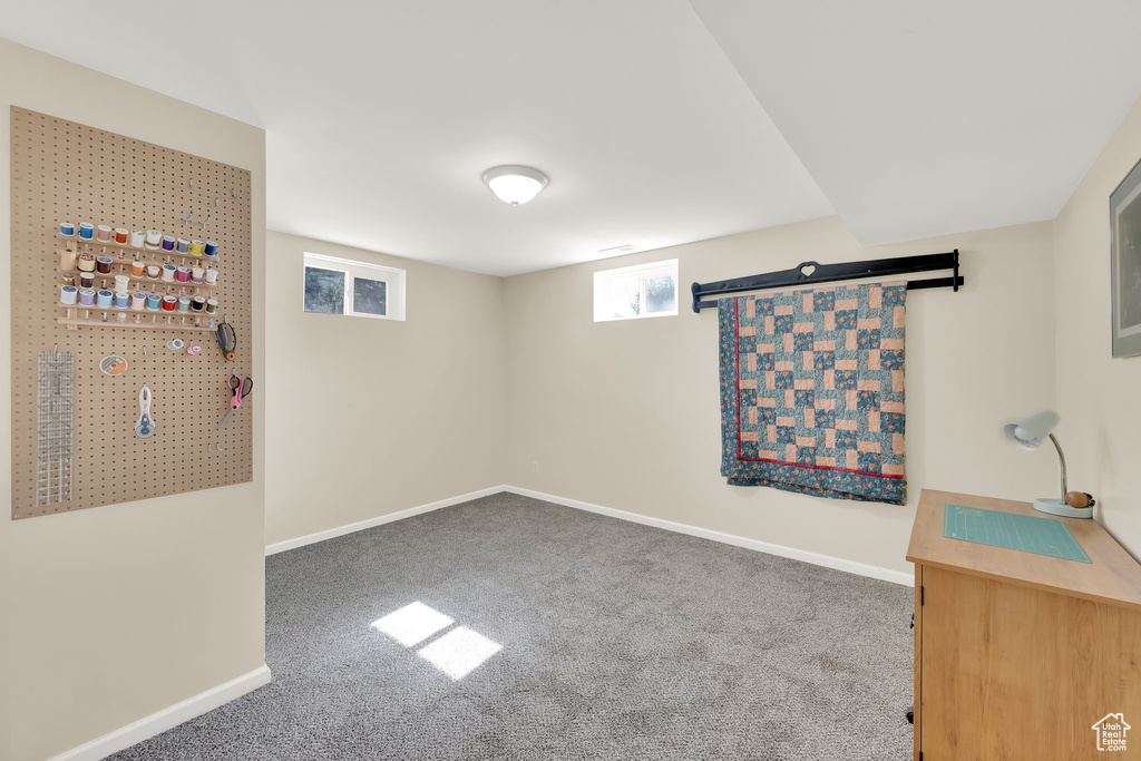 Basement featuring carpet floors and baseboards