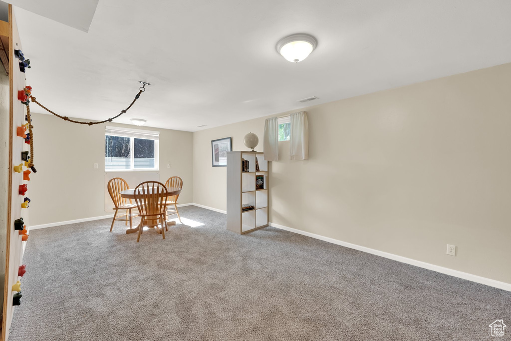 Dining space with carpet floors and baseboards