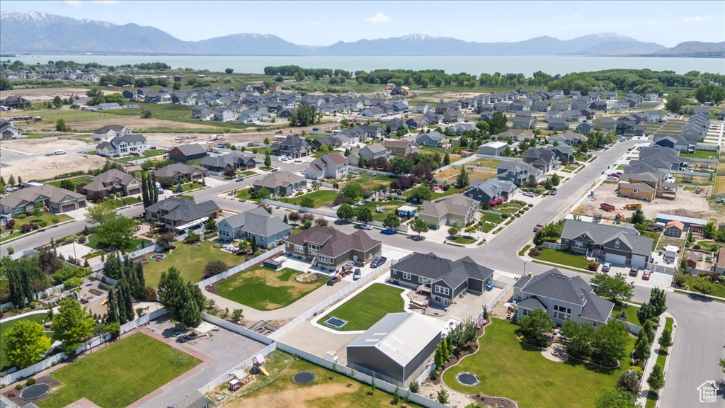 Aerial overview of property's location featuring nearby suburban area and a water and mountain view