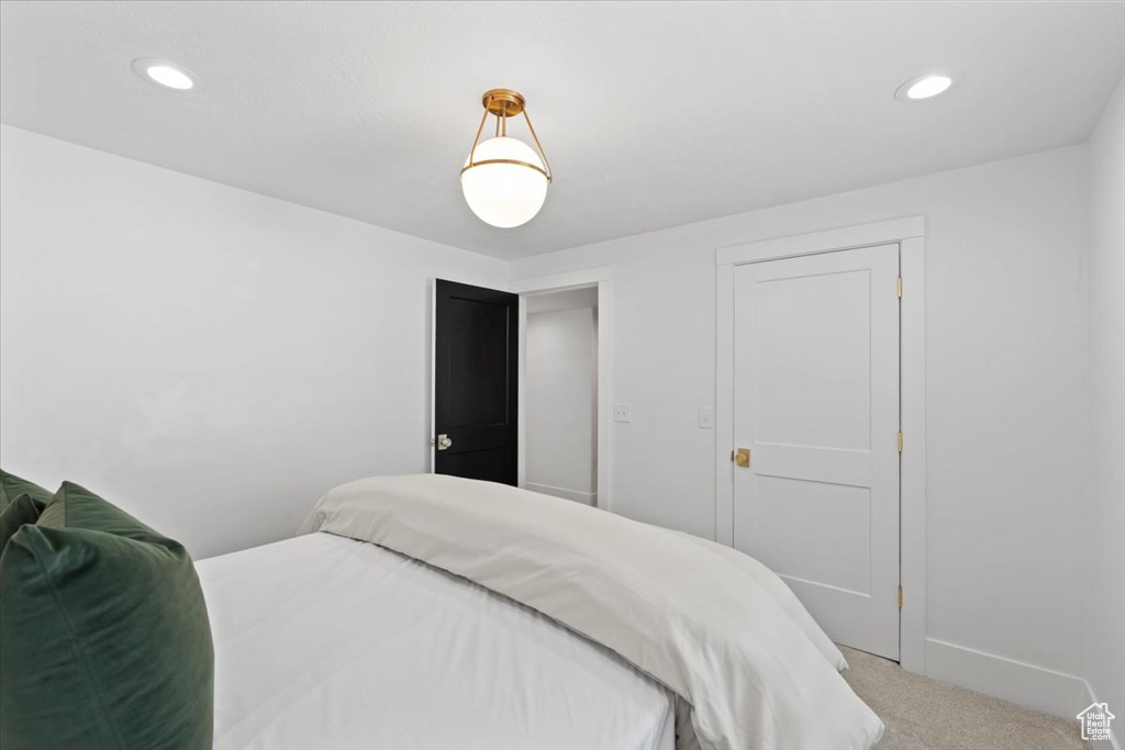 Carpeted bedroom with baseboards and recessed lighting