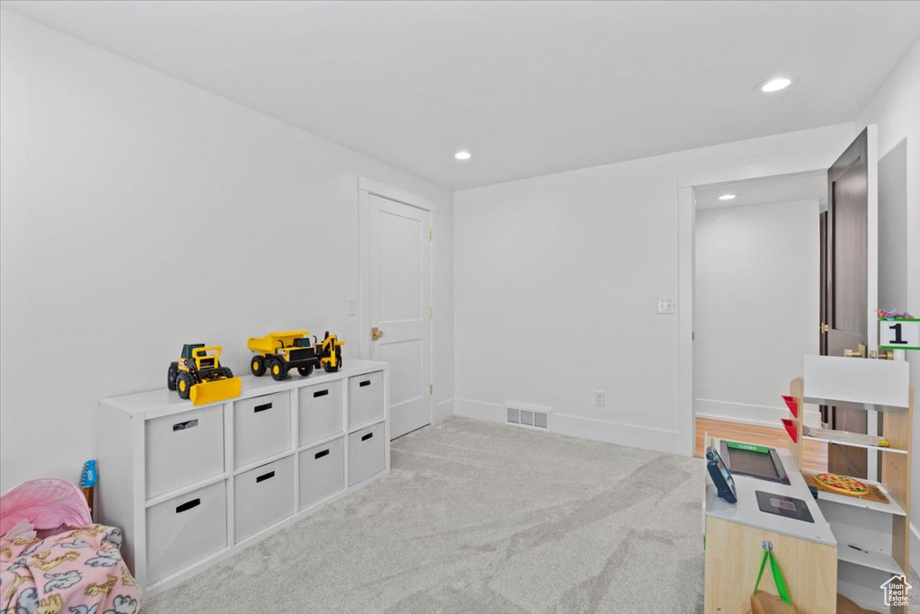 Playroom with recessed lighting, light carpet, and baseboards