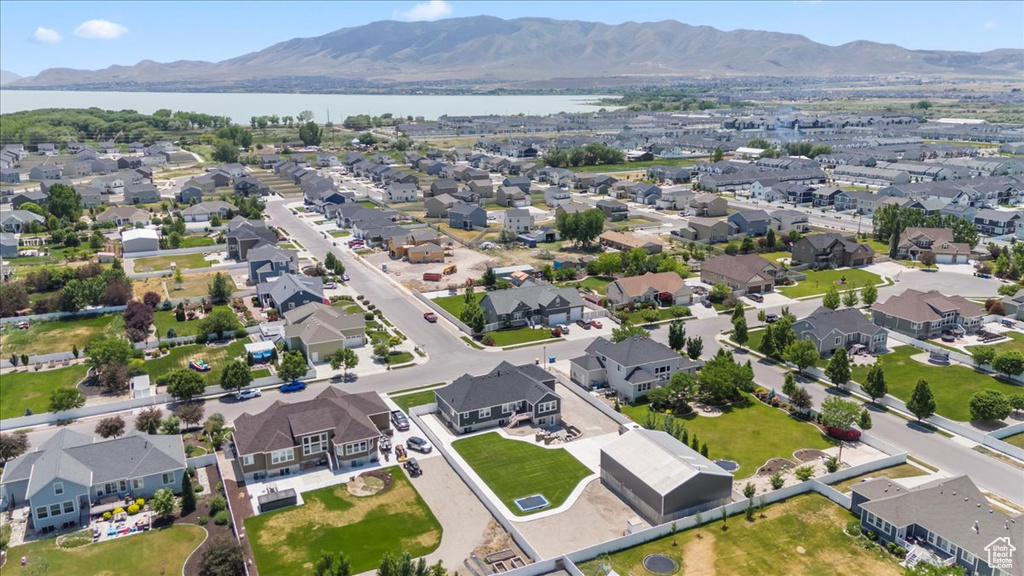 View of property location with a water and mountain view and nearby suburban area