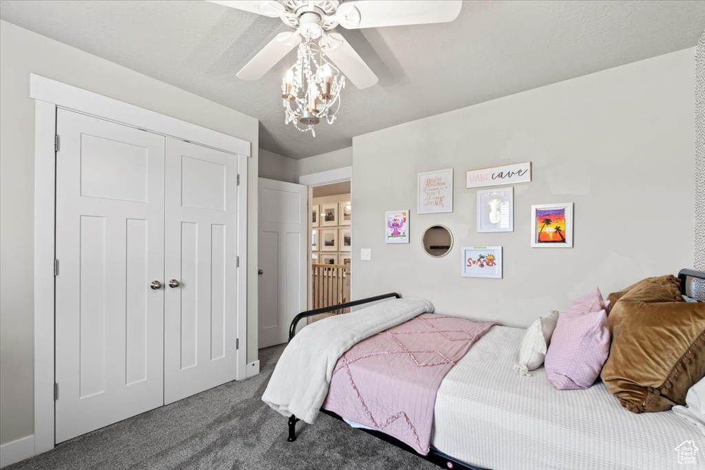 Carpeted bedroom with a closet and ceiling fan