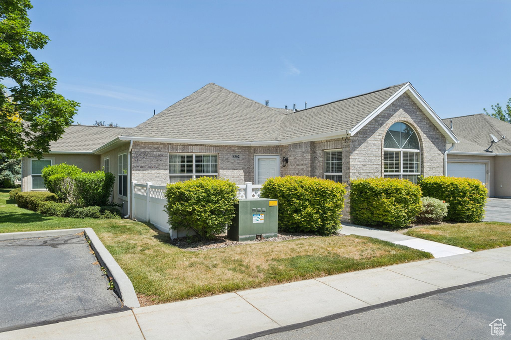 Single story home with roof with shingles