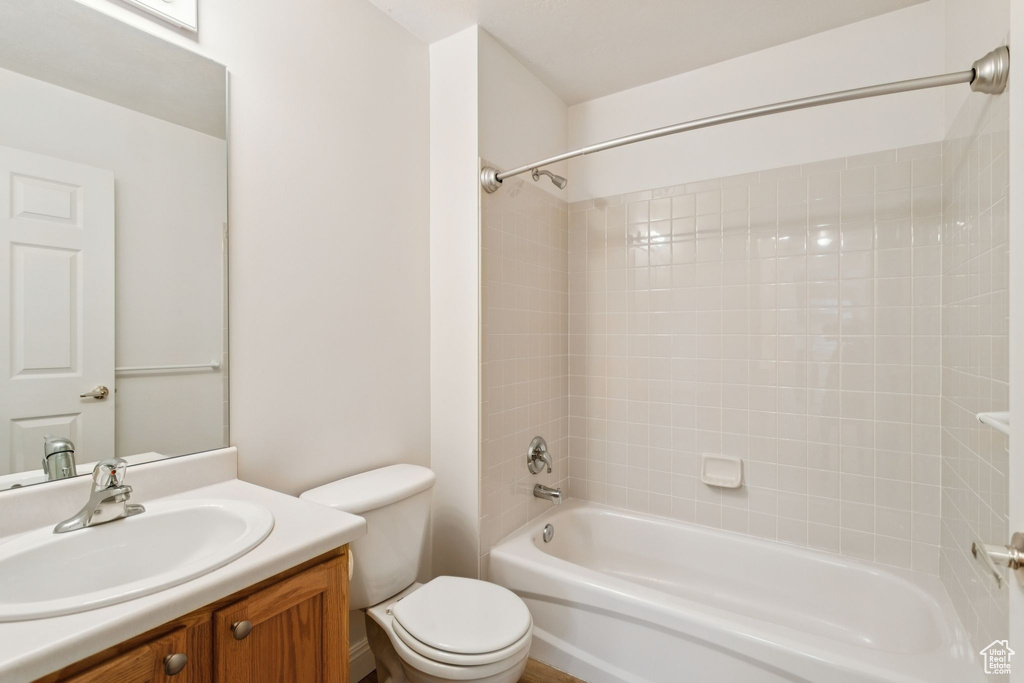 Bathroom featuring vanity, bathing tub / shower combination, and toilet