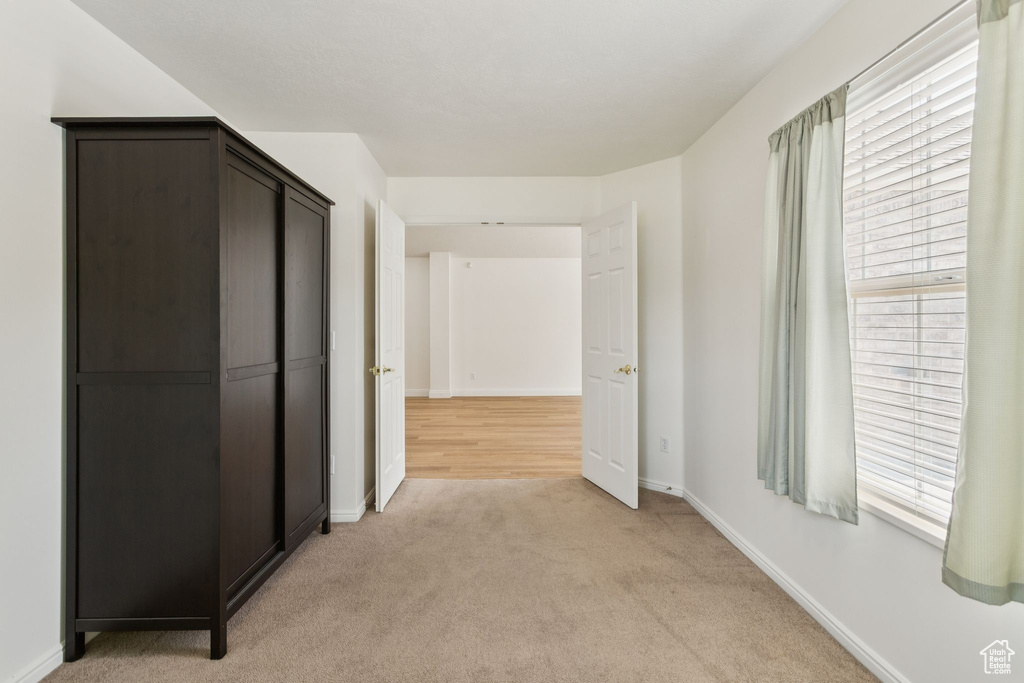 Hall with light carpet and baseboards