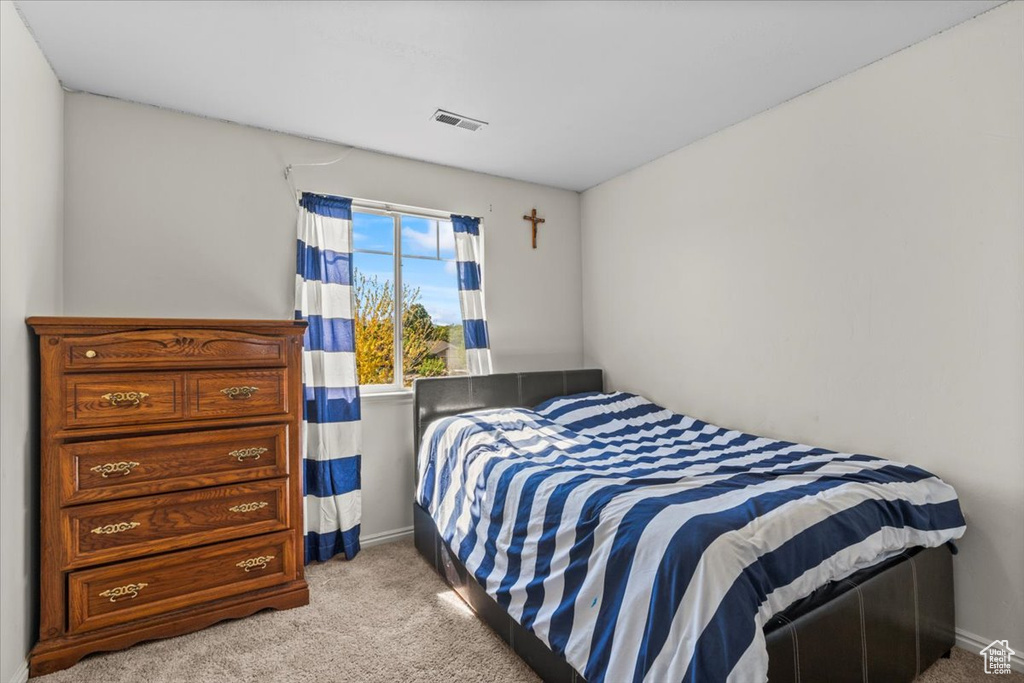 Bedroom with light carpet and baseboards