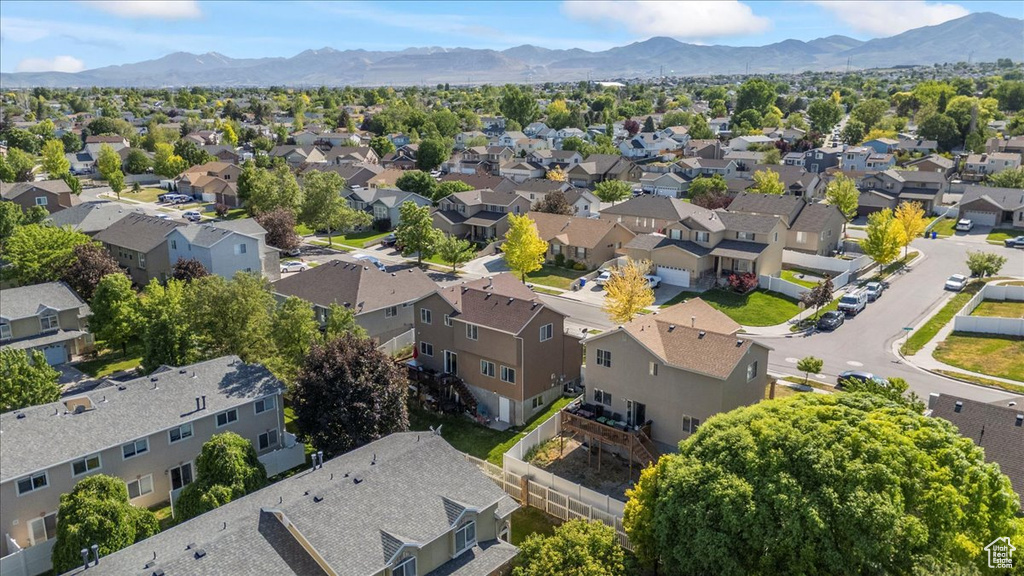 Aerial perspective of suburban area featuring a mountainous background