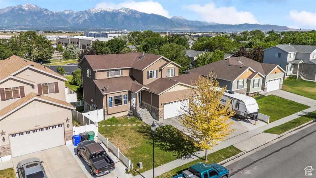 Aerial view of residential area featuring a mountainous background