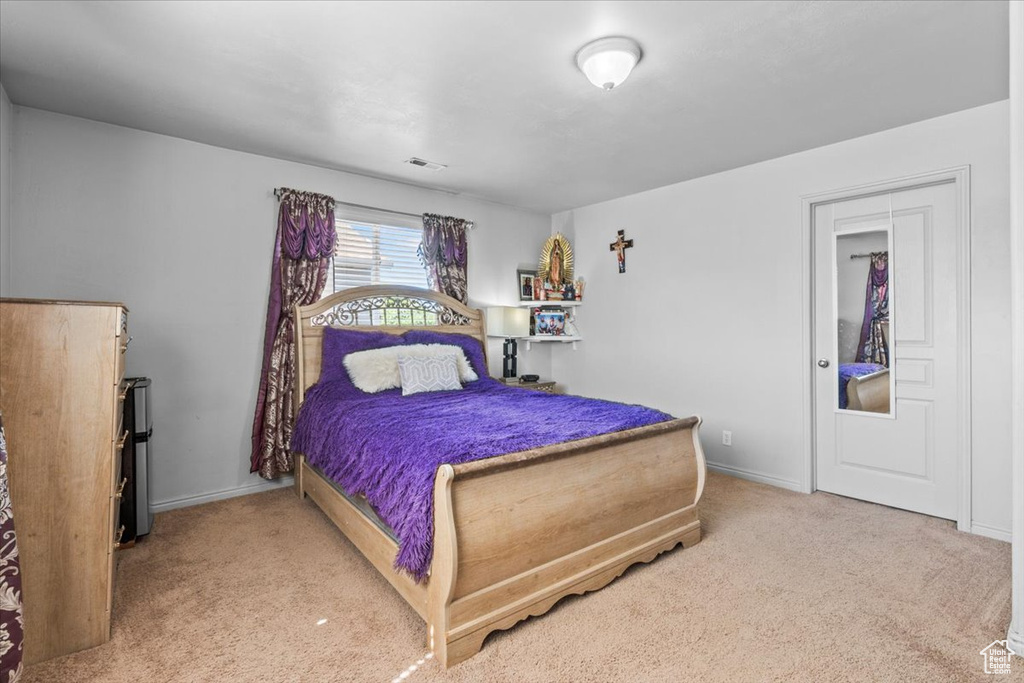 Carpeted bedroom with baseboards