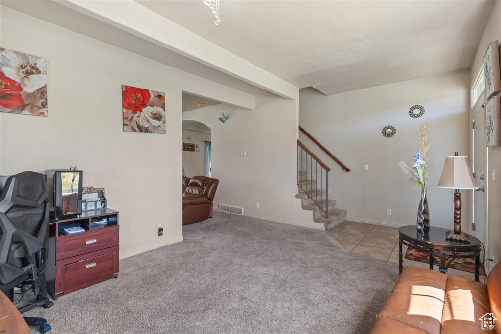 Carpeted office space with arched walkways and baseboards