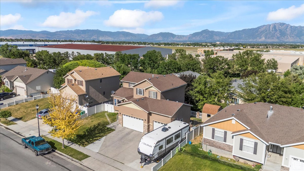 Aerial view of residential area featuring a mountainous background