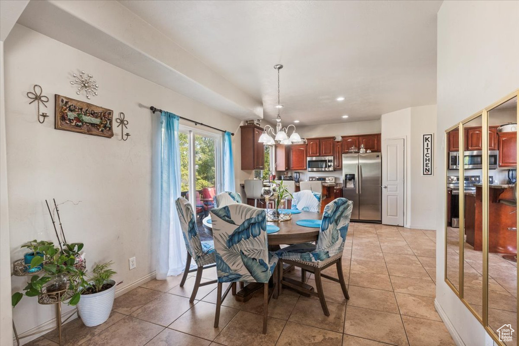 Dining area featuring a chandelier and light tile patterned flooring