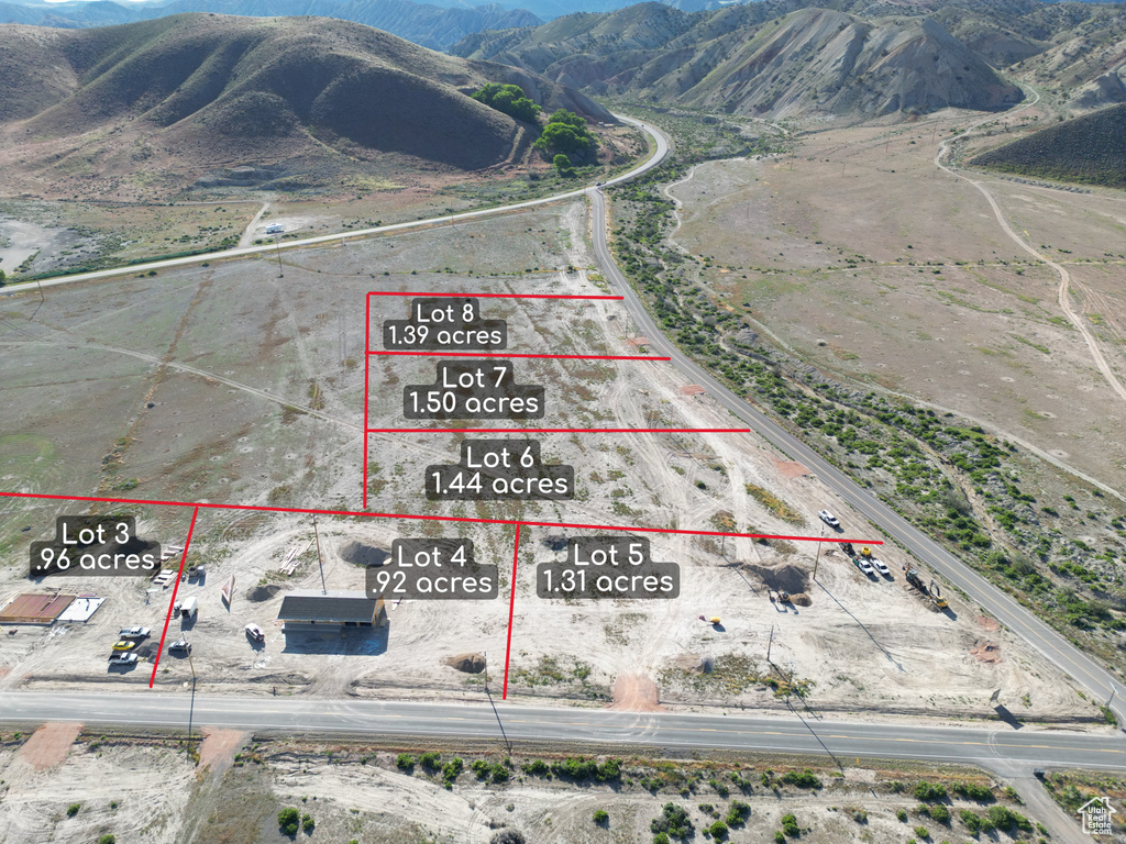 Aerial view of property\'s location featuring a mountain backdrop and property parcel outlined