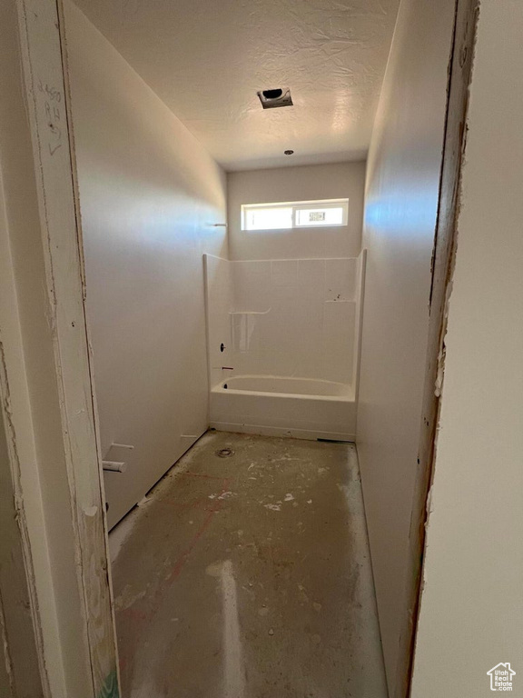 Hallway with a textured ceiling