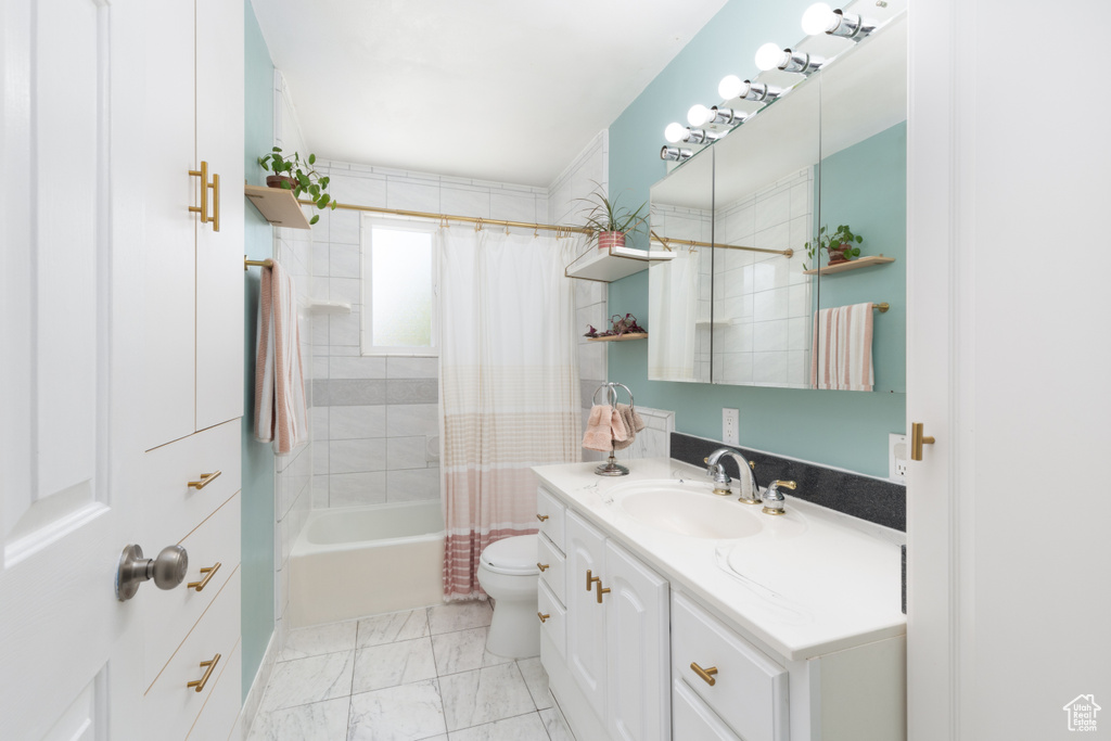 Full bath with vanity, shower / bathtub combination with curtain, toilet, and marble look tile flooring