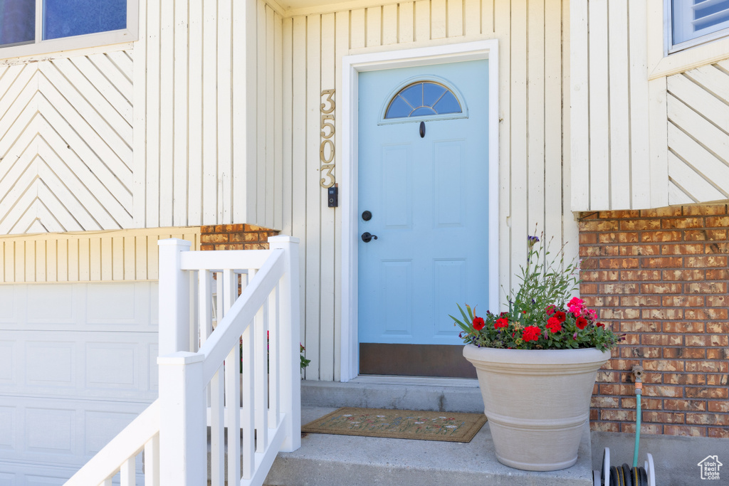 Entrance to property featuring a garage and board and batten siding