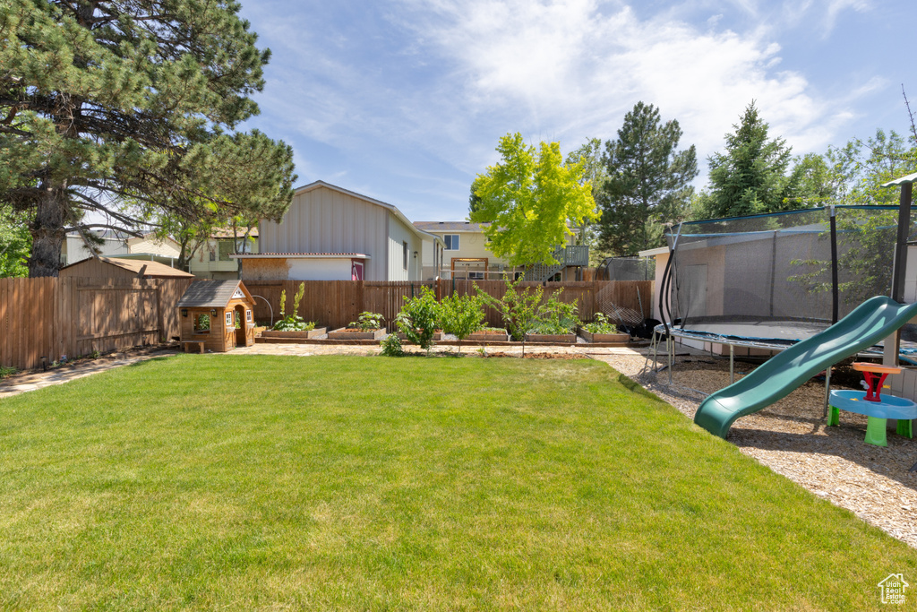 View of yard with a trampoline