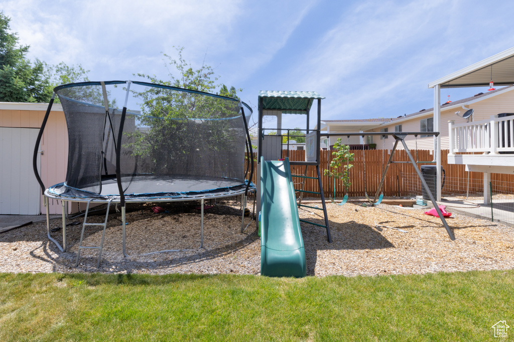 View of jungle gym featuring a trampoline
