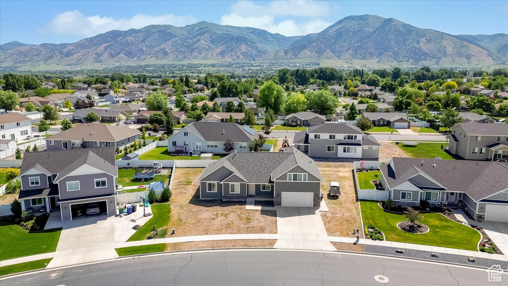 Aerial perspective of suburban area featuring a mountainous background