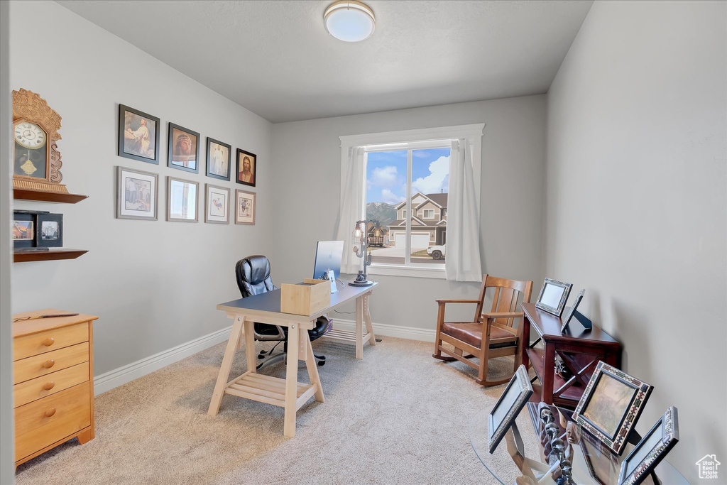 Home office with carpet flooring and baseboards