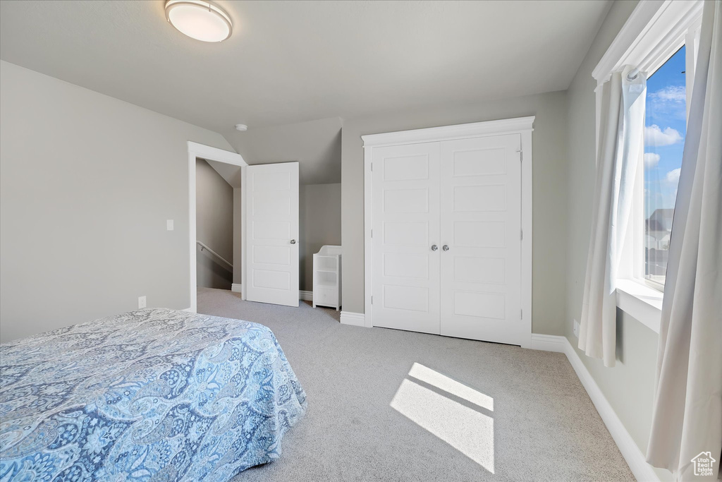Bedroom featuring carpet floors, a closet, and baseboards