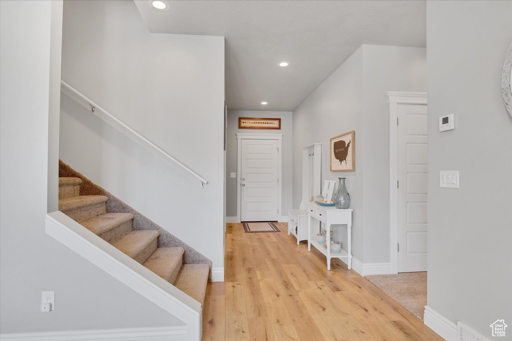 Entrance foyer with stairway, recessed lighting, light wood finished floors, and baseboards