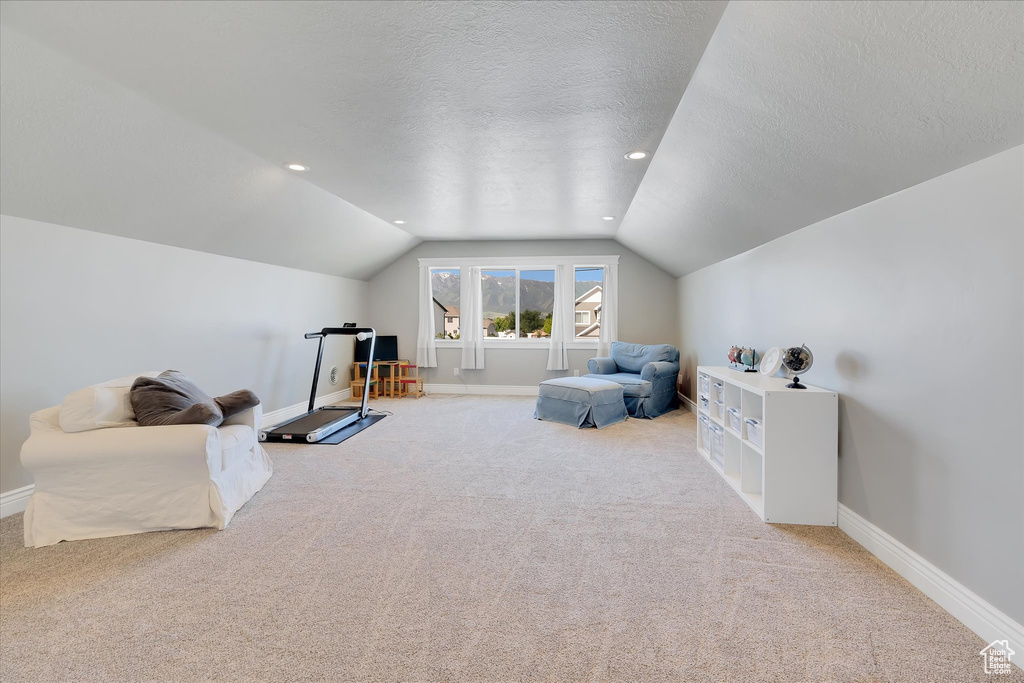 Sitting room with carpet, vaulted ceiling, baseboards, a textured ceiling, and recessed lighting