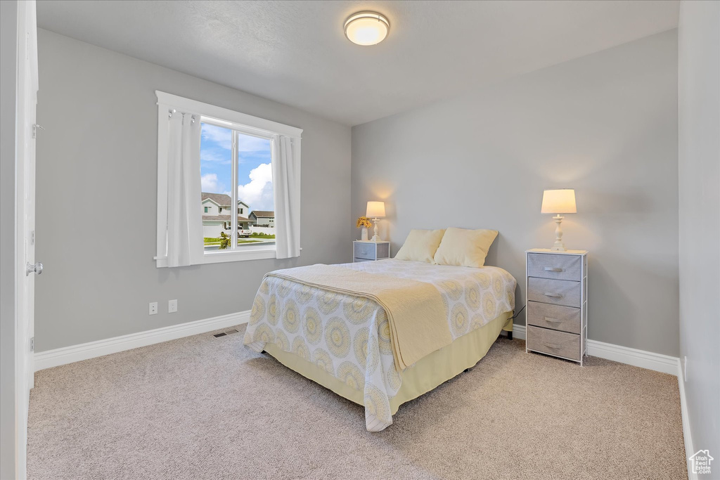 Carpeted bedroom featuring baseboards