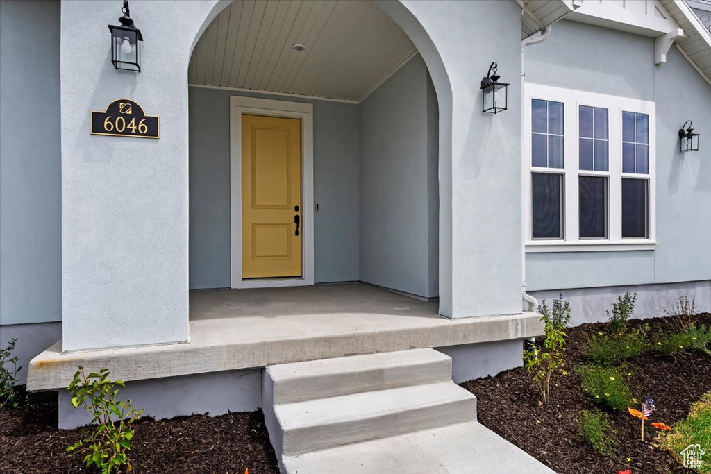 Doorway to property with stucco siding