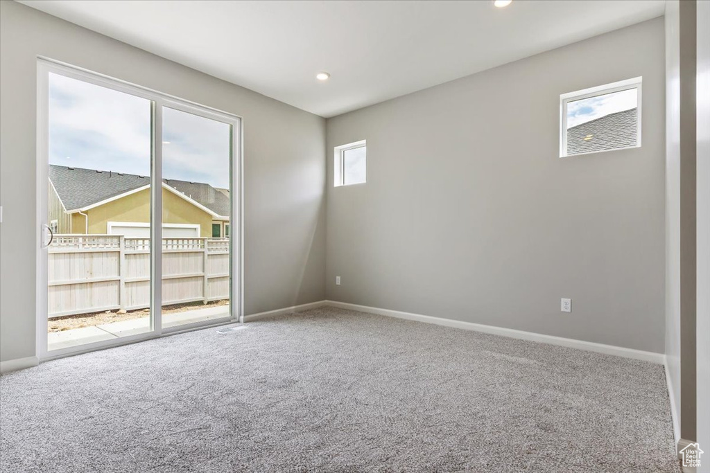 Empty room featuring carpet floors, baseboards, and recessed lighting