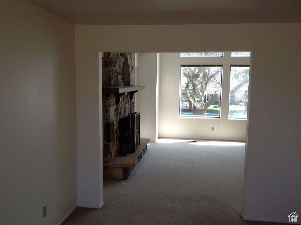 Unfurnished living room featuring carpet
