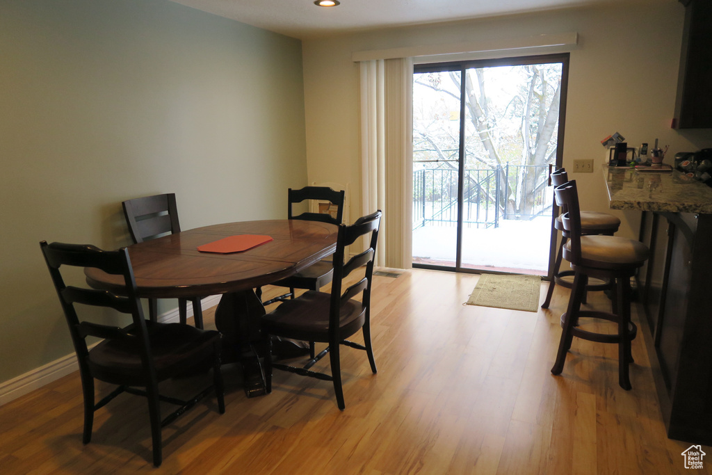 Dining area featuring light wood-style flooring, recessed lighting, and baseboards
