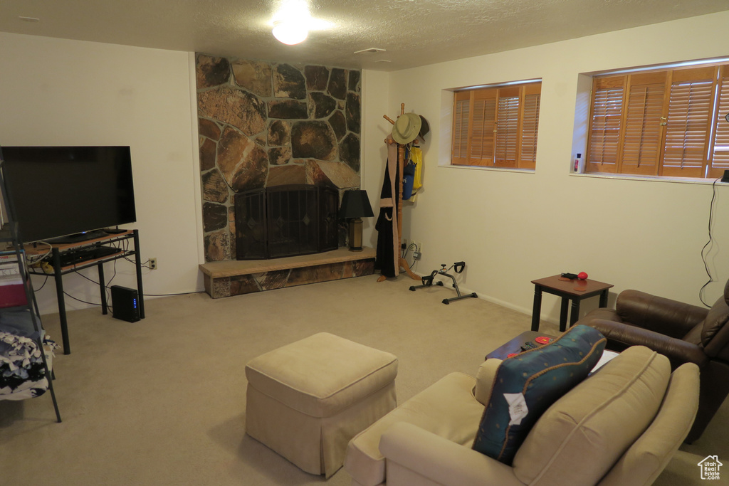 Living area with carpet flooring and a textured ceiling