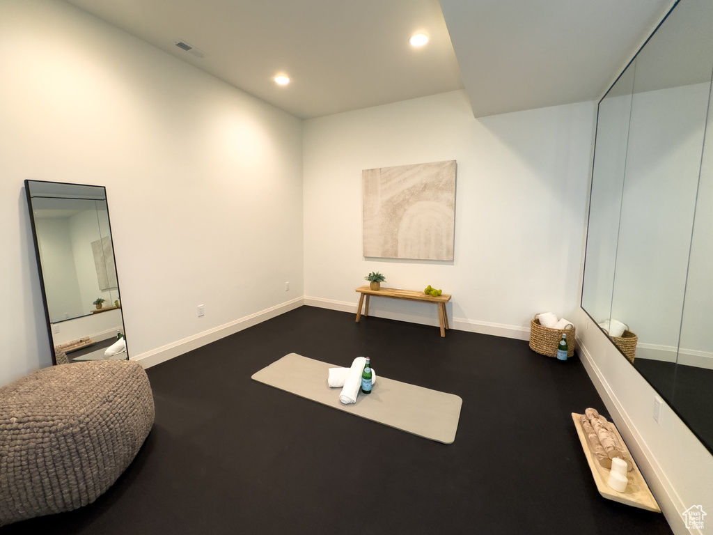 Workout area with baseboards and recessed lighting