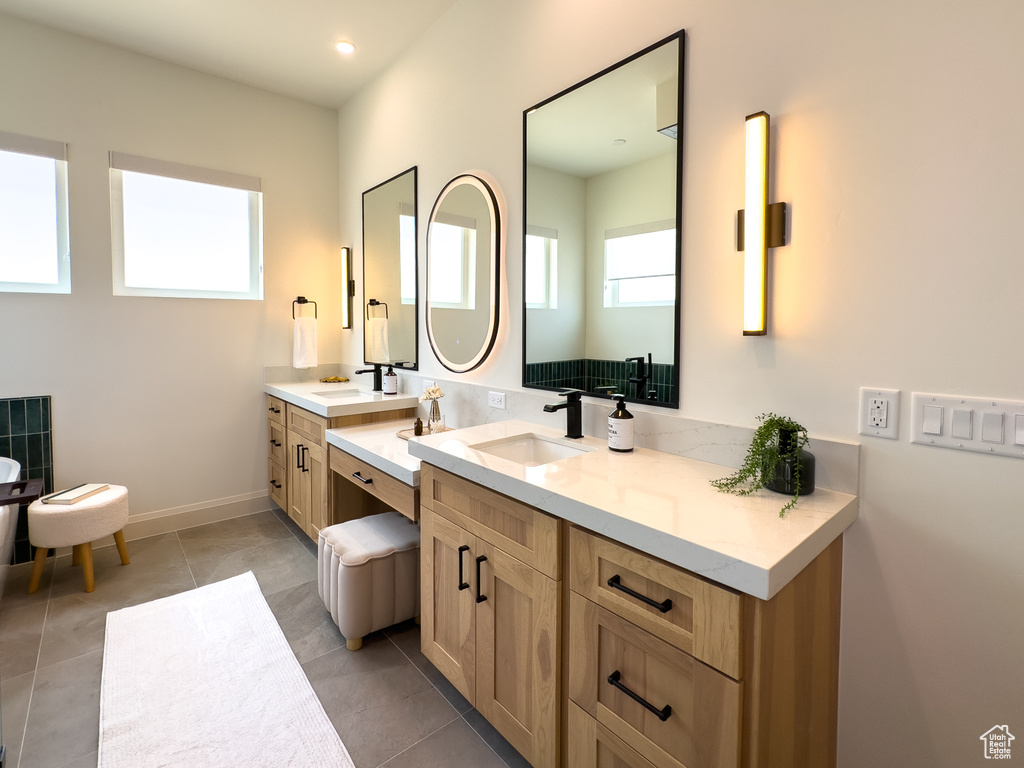 Full bath featuring vanity, baseboards, and tile patterned floors