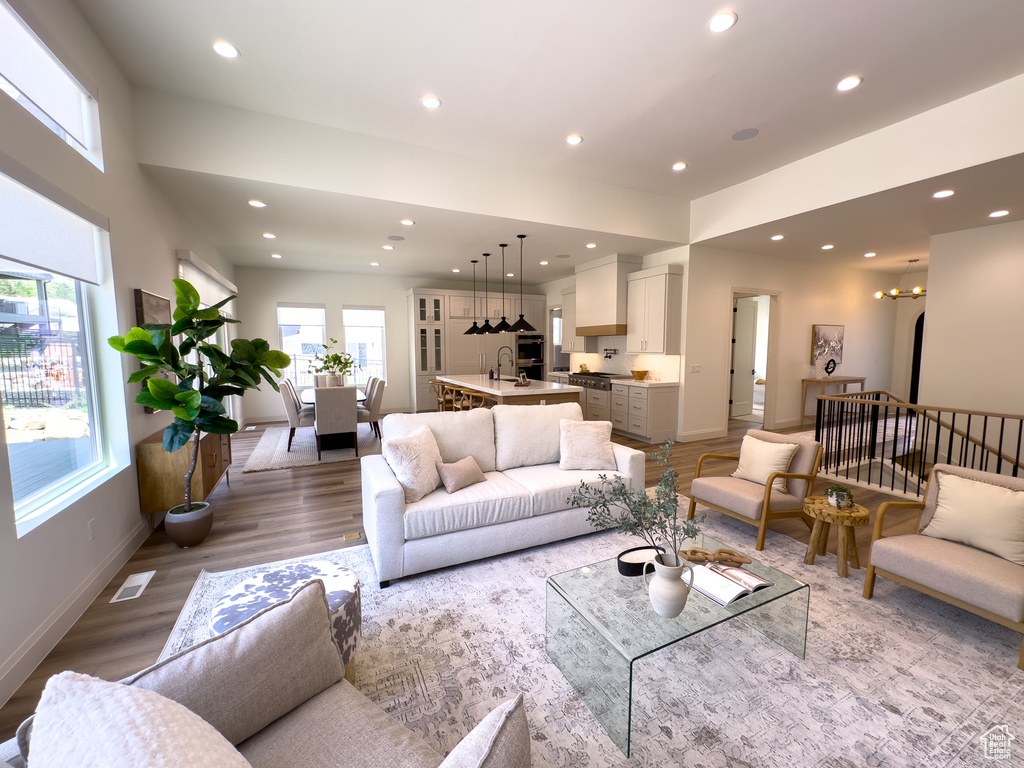 Living area with recessed lighting, light wood finished floors, and baseboards