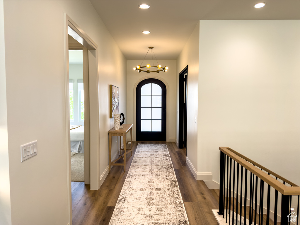 Foyer with plenty of natural light, dark wood finished floors, recessed lighting, and a chandelier