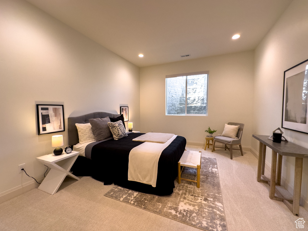Bedroom with light carpet, recessed lighting, and baseboards
