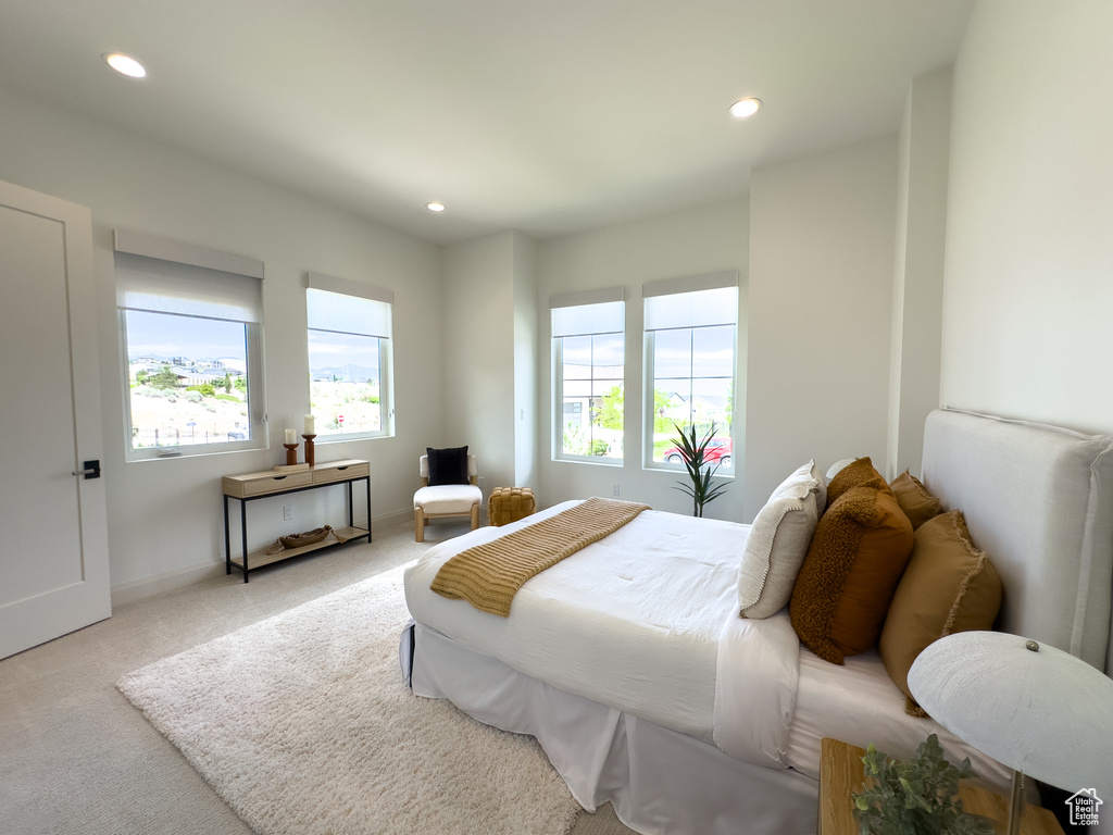 Carpeted bedroom with recessed lighting and baseboards