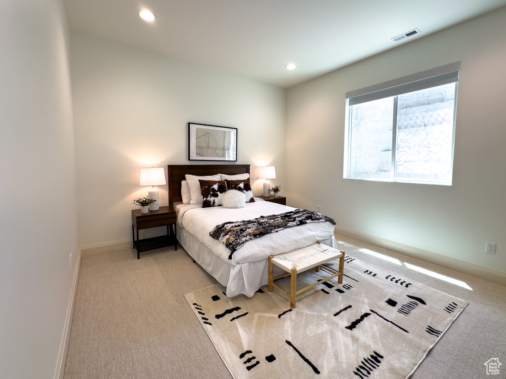Carpeted bedroom with baseboards and recessed lighting