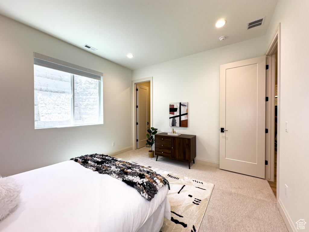 Bedroom featuring light colored carpet, baseboards, and recessed lighting