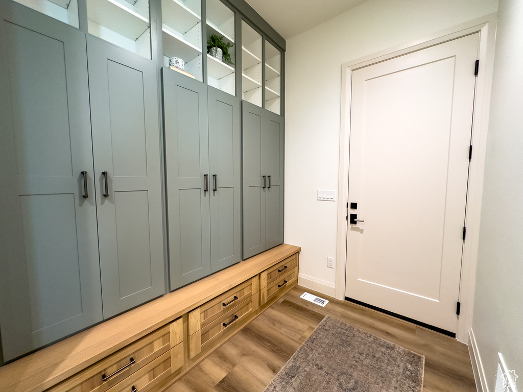 Mudroom featuring light wood-type flooring and baseboards