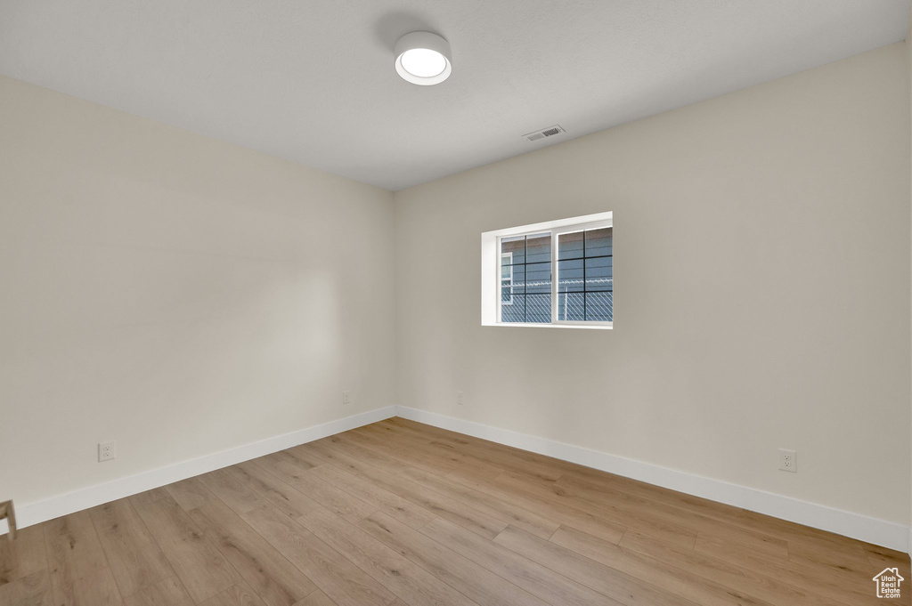 Empty room featuring wood finished floors and baseboards