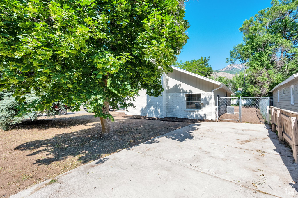 View of side of property with brick siding and a mountain view