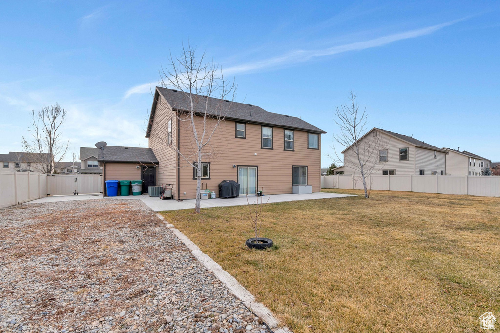Rear view of property with a patio area and a gate