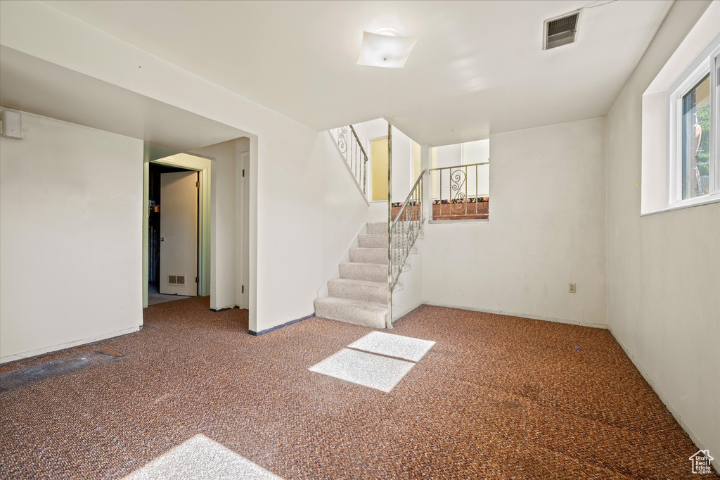 Below grade area featuring carpet flooring and stairs