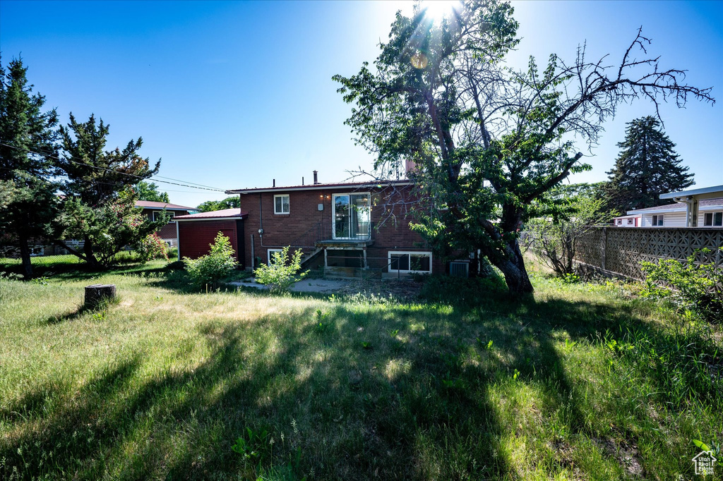 Rear view of property featuring brick siding