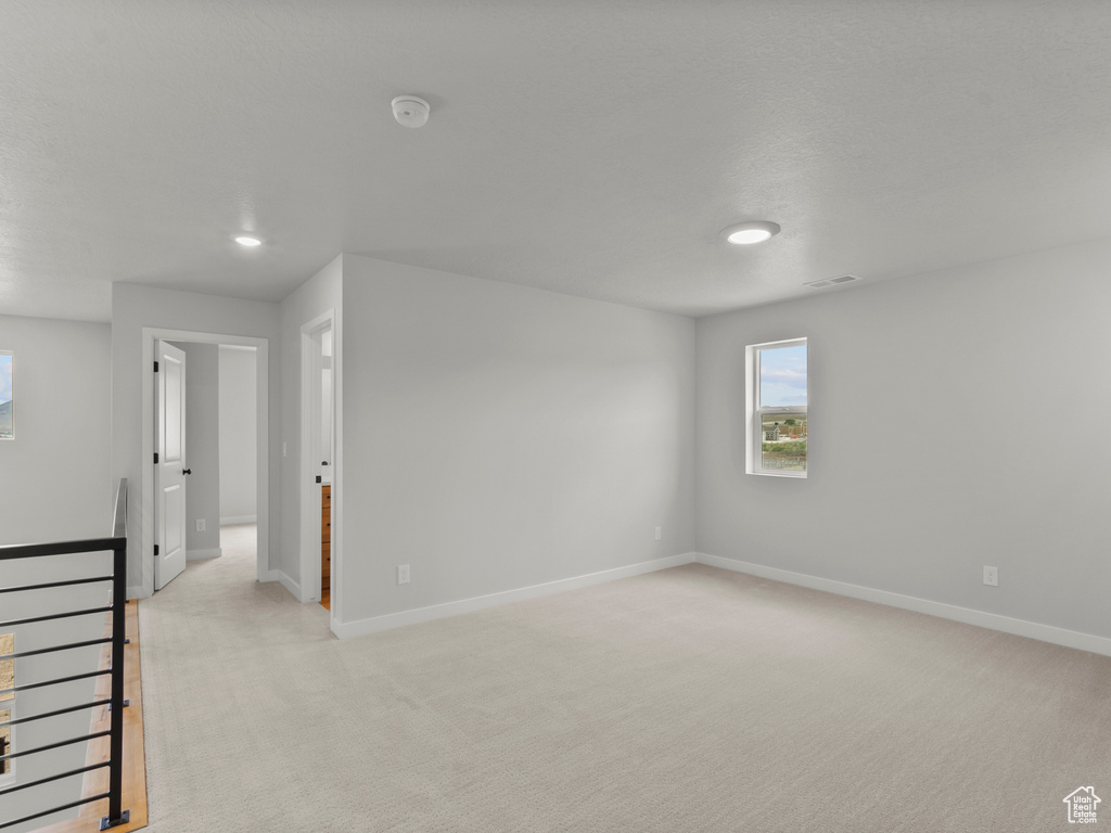 Unfurnished room with light carpet and recessed lighting