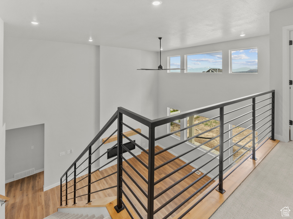 Stairway featuring recessed lighting and wood finished floors